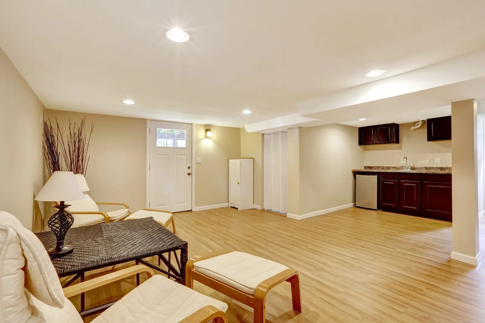 Finished basement family room with wood-look flooring, recessed lighting and a wet bar, basement remodel in Boise, Idaho