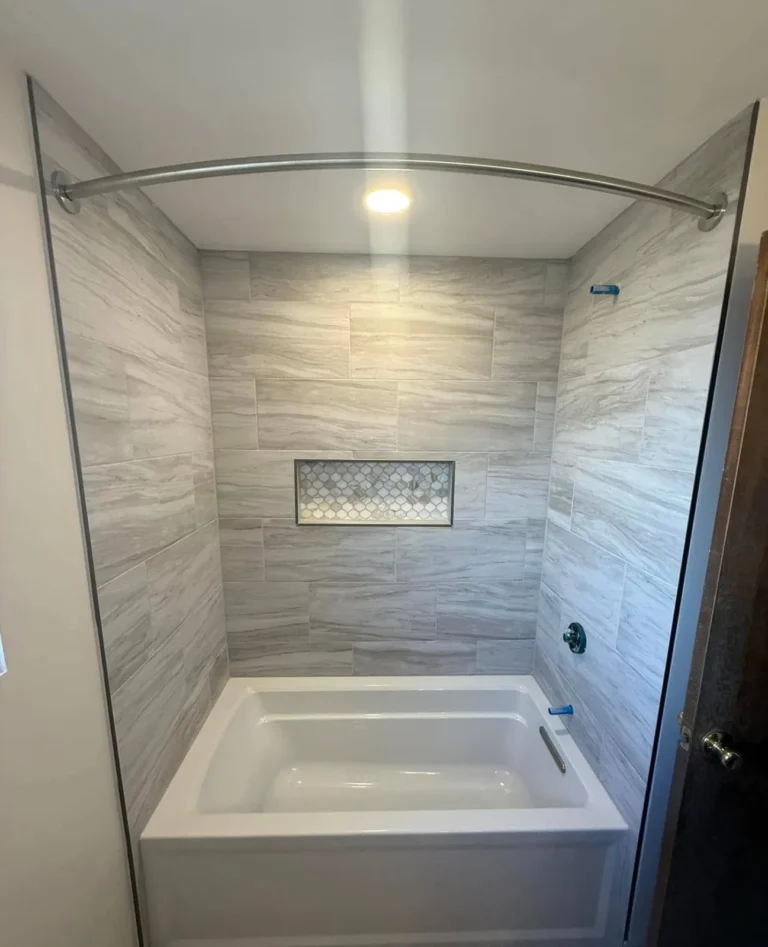 Bathroom remodel in Boise, Idaho with a soaking tub, stone-look tile surround and mosaic shower niche