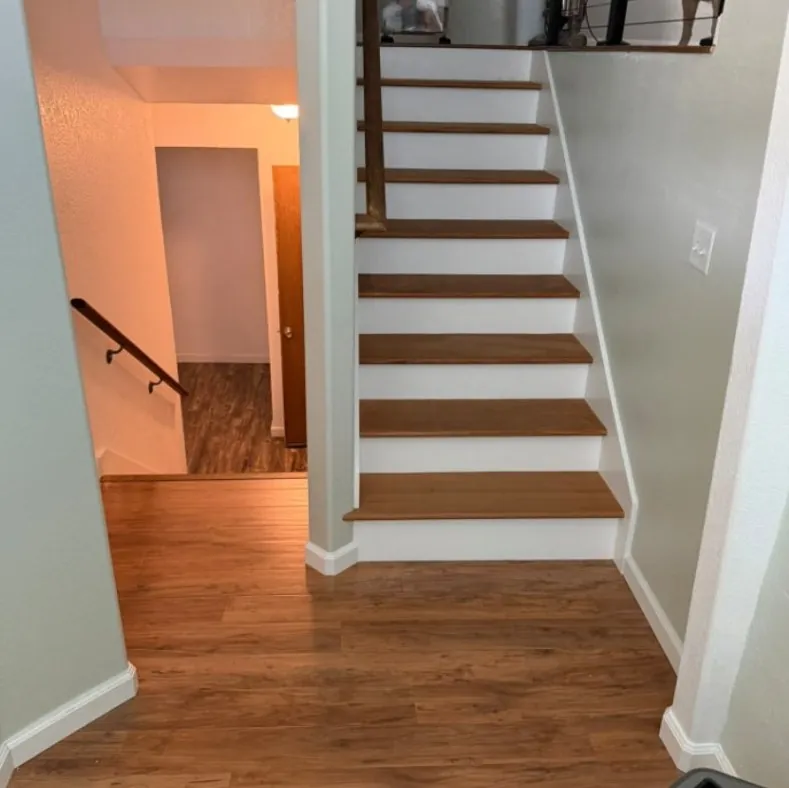 Interior staircase with new wood treads and white risers from a home remodel in Meridian, Idaho
