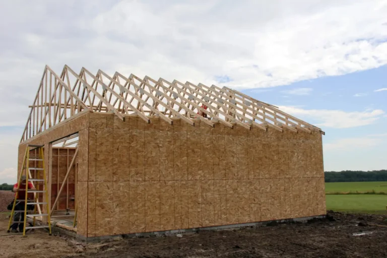 Detached shop building under construction with sheathed walls, roof trusses and a large door opening, shop builder in Boise, Idaho