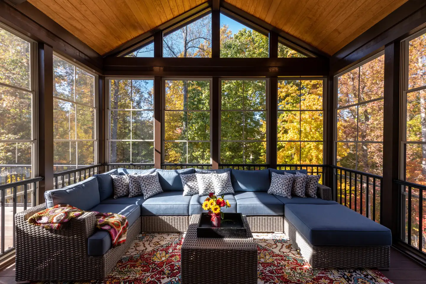 Bright three-season sunroom with a vaulted wood ceiling, floor-to-ceiling windows and a sectional sofa, sunrooms in Boise, Idaho